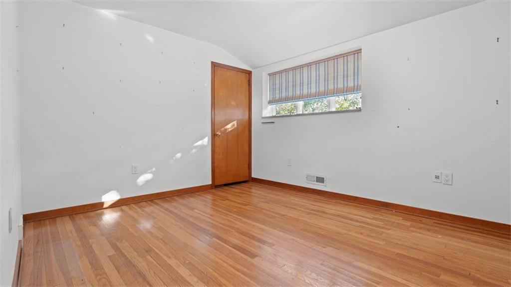 507 Rochester Road Rochester, PA 15074 - Photo 22 of 35 a view of an empty room with wooden floor and a window