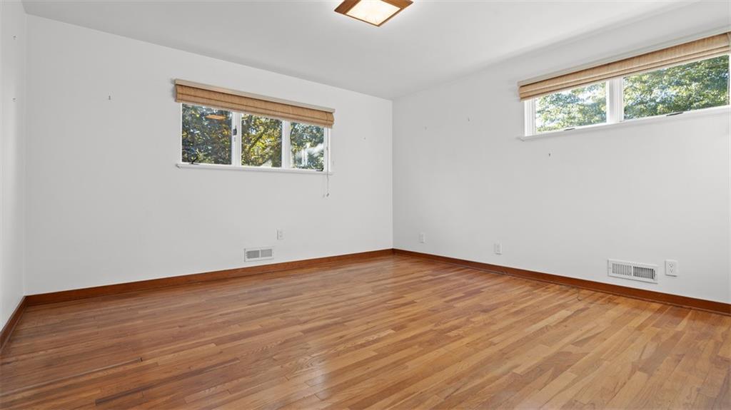 507 Rochester Road Rochester, PA 15074 - Photo 23 of 35 a view of an empty room with wooden floor and a window