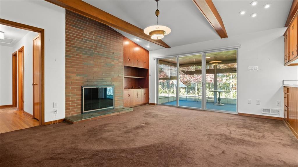 507 Rochester Road Rochester, PA 15074 - Photo 3 of 35 a view of empty room with a fireplace and fan