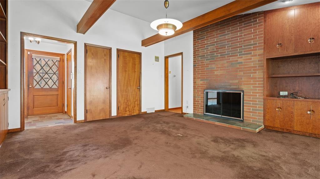 507 Rochester Road Rochester, PA 15074 - Photo 5 of 35 a view of an empty room with a fireplace and a window