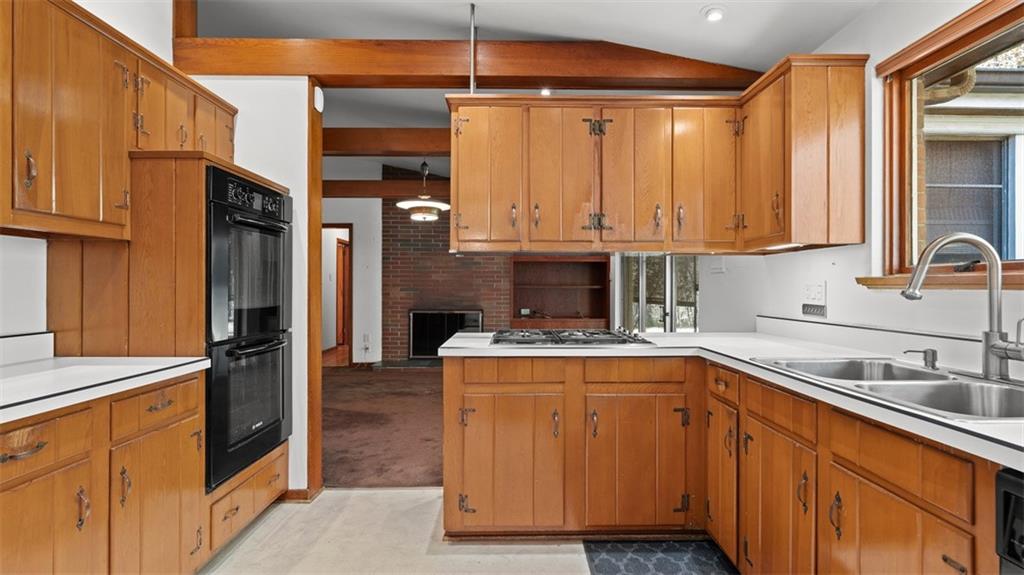 507 Rochester Road Rochester, PA 15074 - Photo 6 of 35 a kitchen with stainless steel appliances granite countertop a sink stove and refrigerator