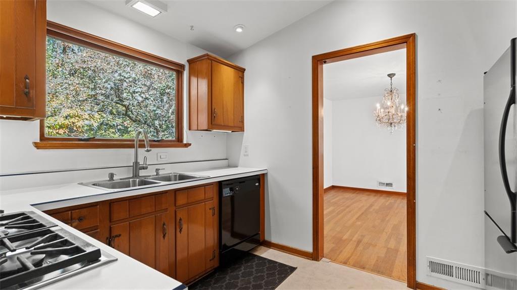 507 Rochester Road Rochester, PA 15074 - Photo 9 of 35 a kitchen with stainless steel appliances granite countertop a sink stove and refrigerator