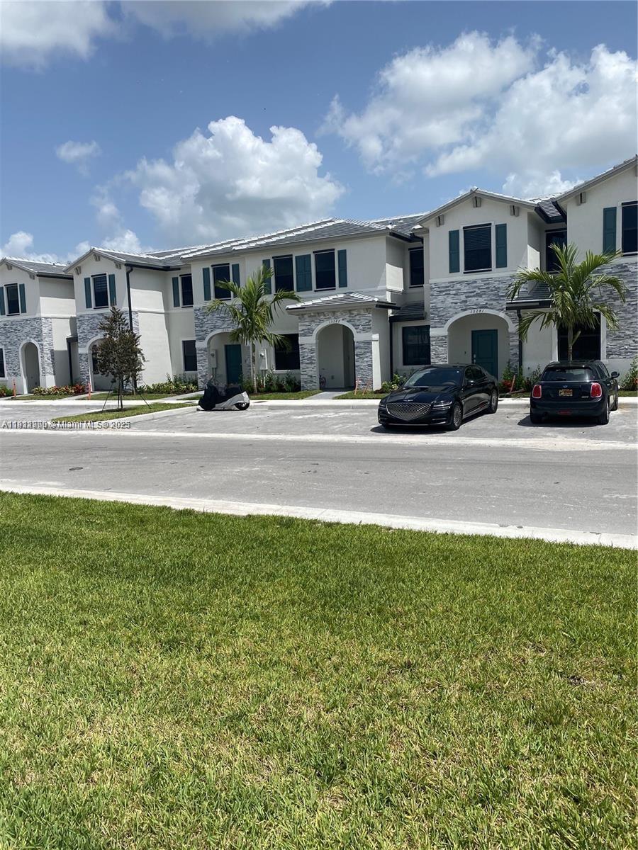 13281 Southwest 285th Street Homestead, FL 33033 - Photo 14 of 27 a front view of a house with a yard and garage