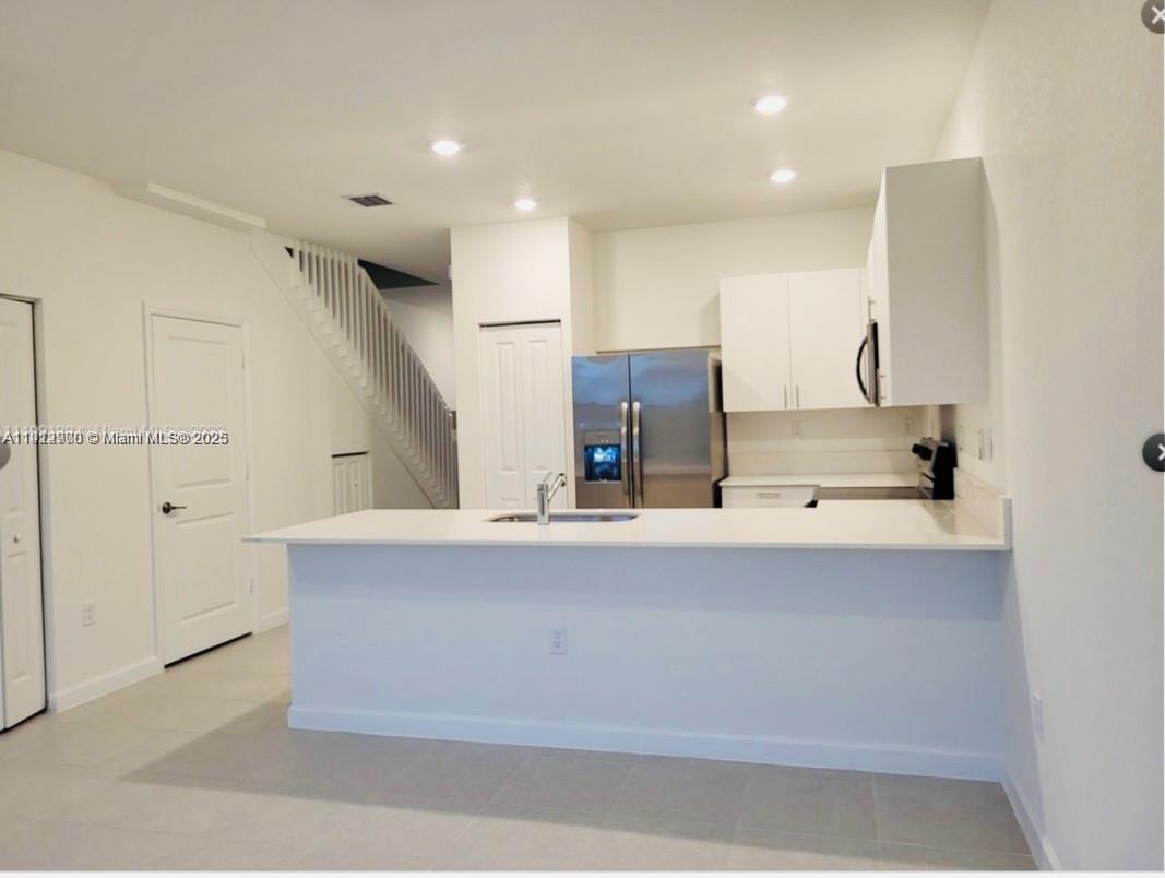 13281 Southwest 285th Street Homestead, FL 33033 - Photo 18 of 27 a view of kitchen with cabinets and window