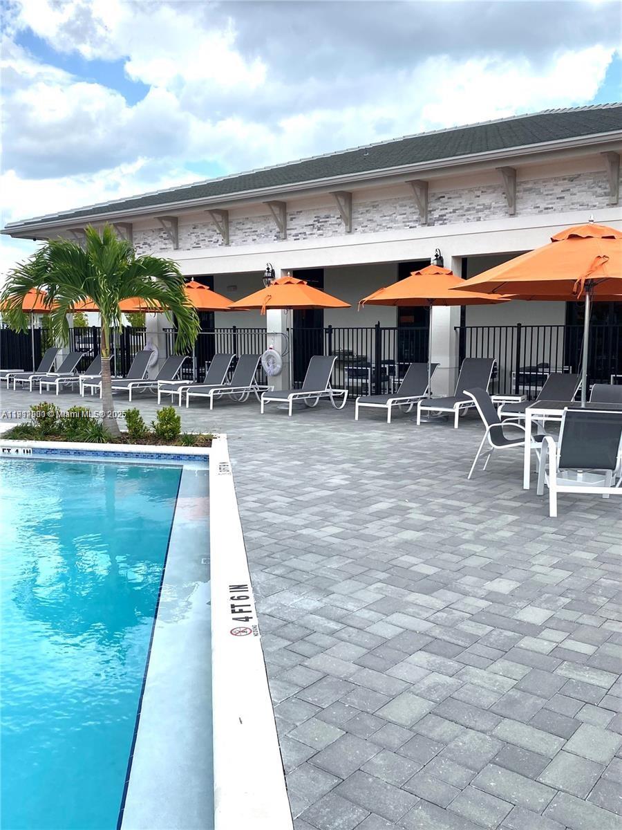 13281 Southwest 285th Street Homestead, FL 33033 - Photo 6 of 27 a view of a swimming pool with outdoor seating