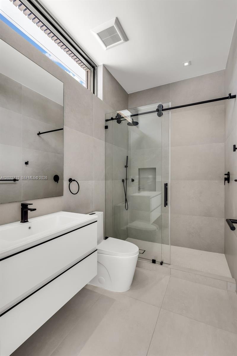 7825 Southwest 128th Street Pinecrest, FL 33156 - Photo 45 of 88 a bathroom with a sink a toilet and shower