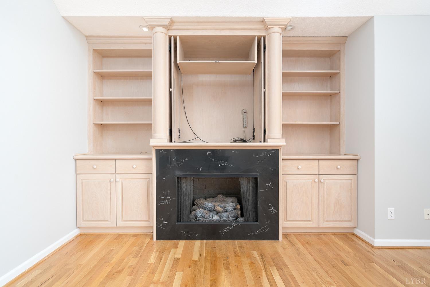 2629 Everett Road Forest, VA 24551 - Photo 12 of 47 a hallway with a fireplace and wooden floor
