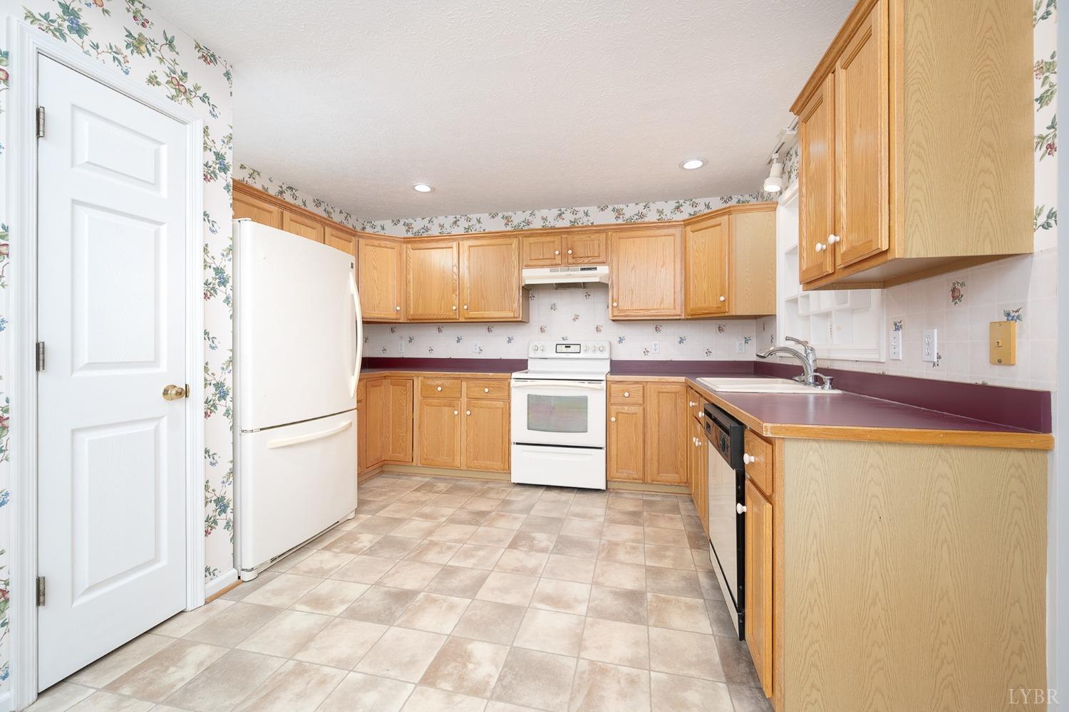 2629 Everett Road Forest, VA 24551 - Photo 15 of 47 a kitchen with a refrigerator sink and cabinets