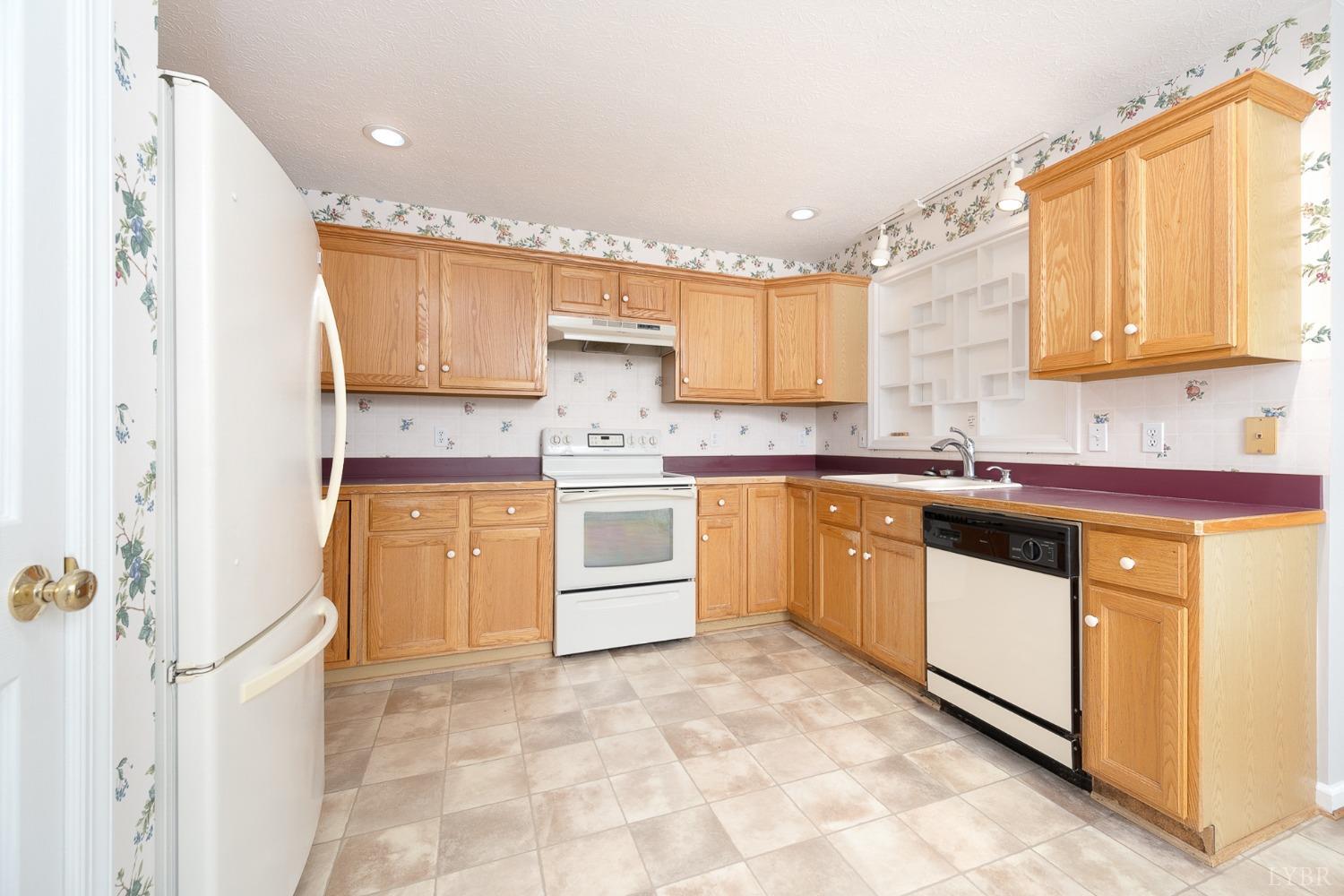 2629 Everett Road Forest, VA 24551 - Photo 16 of 47 a kitchen with a white cabinets and white appliances