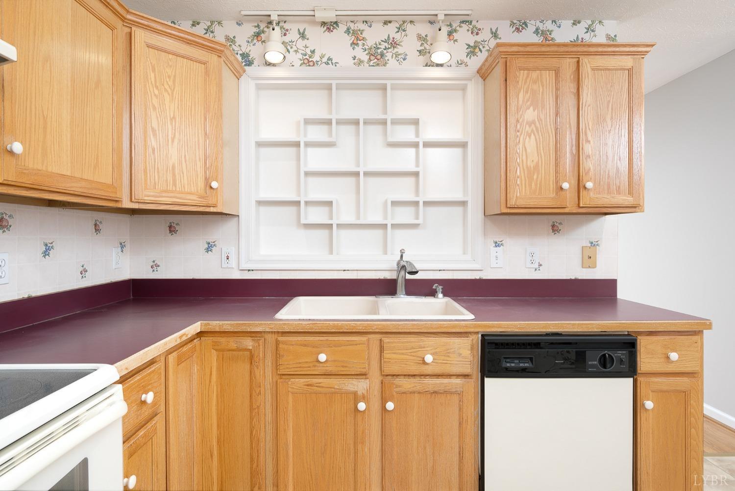 2629 Everett Road Forest, VA 24551 - Photo 17 of 47 a kitchen with a sink a cabinets and window