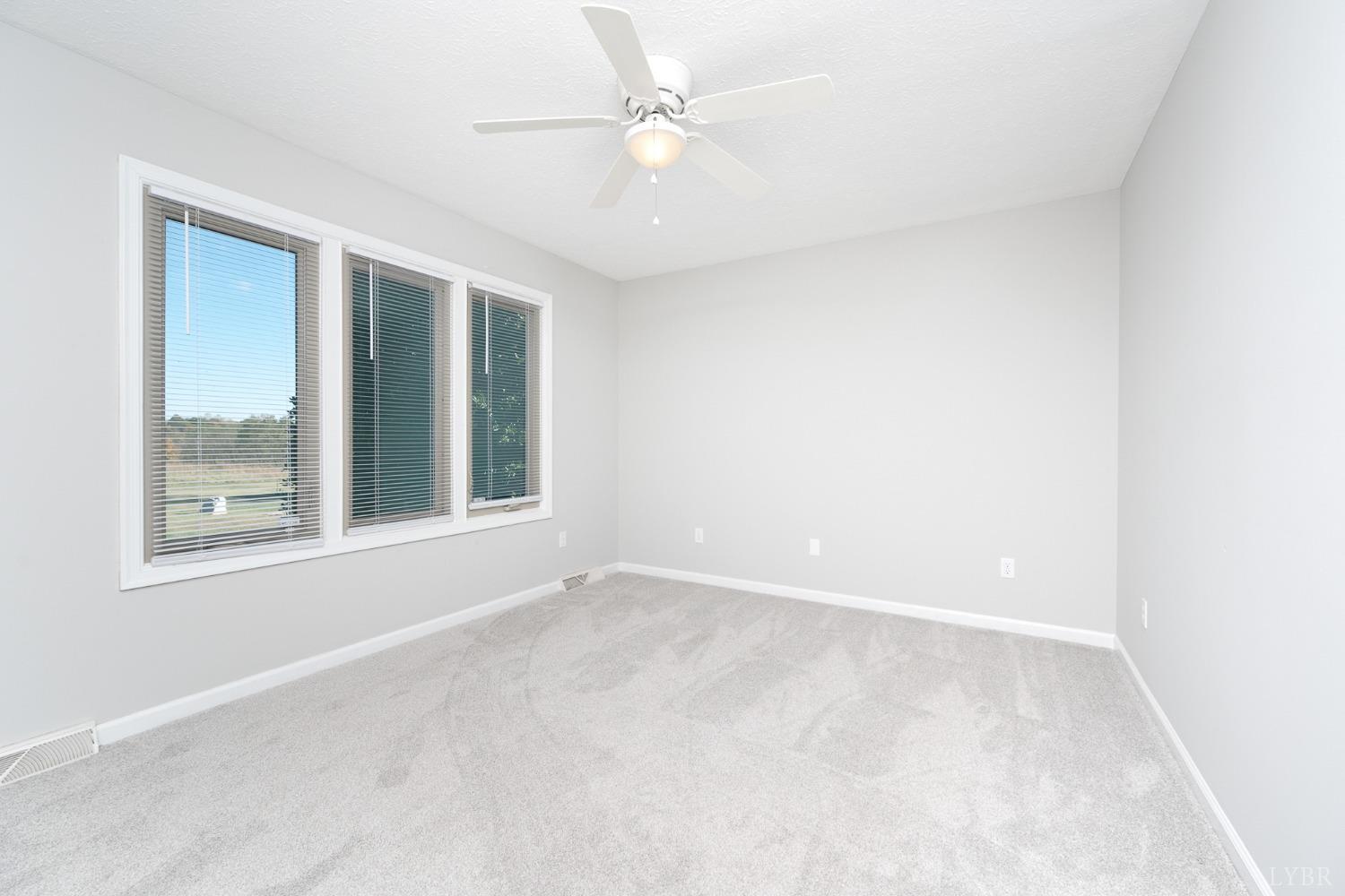 2629 Everett Road Forest, VA 24551 - Photo 32 of 47 an empty room with a window and a fan