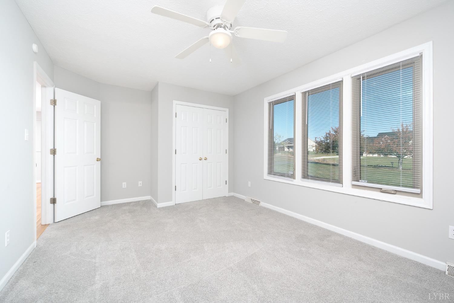 2629 Everett Road Forest, VA 24551 - Photo 33 of 47 an empty room with chandelier fan and windows