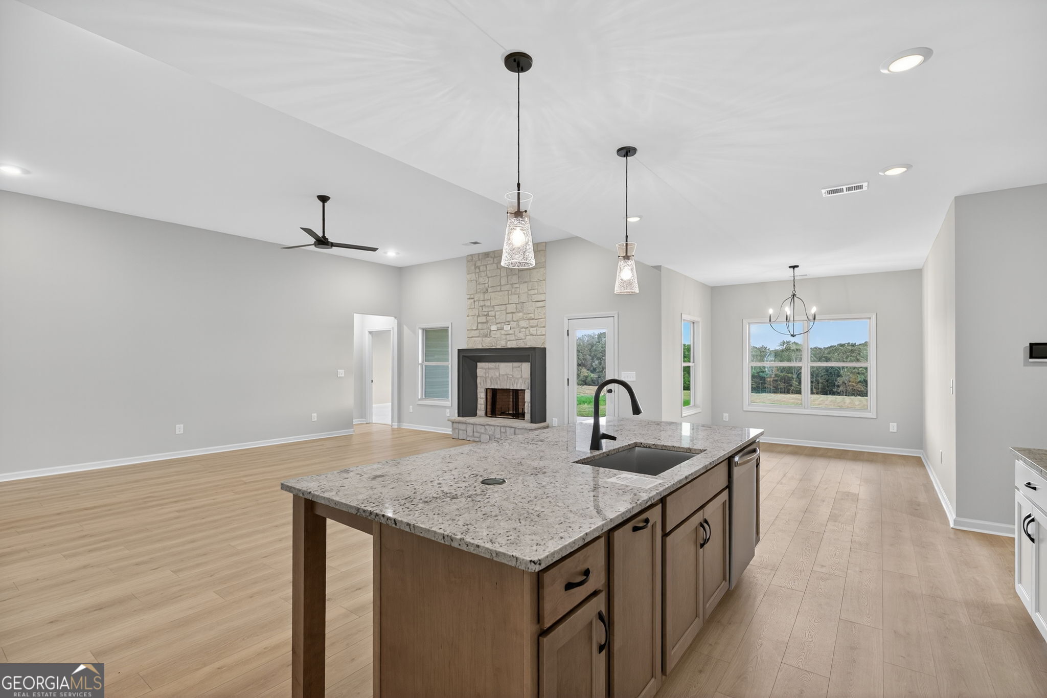 359 Gray Road Roopville, GA 30170 - Photo 22 of 46 a kitchen with a kitchen island a stove a counter space and a fireplace
