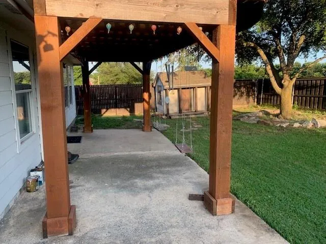 a view of backyard with wooden fence
