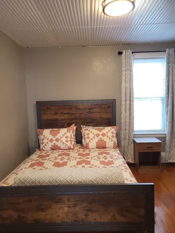 a bedroom with a bed and a window