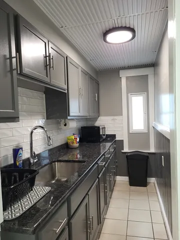 a kitchen with a sink and cabinets