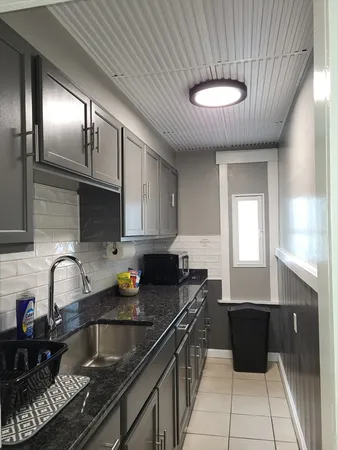 a kitchen with a sink and cabinets