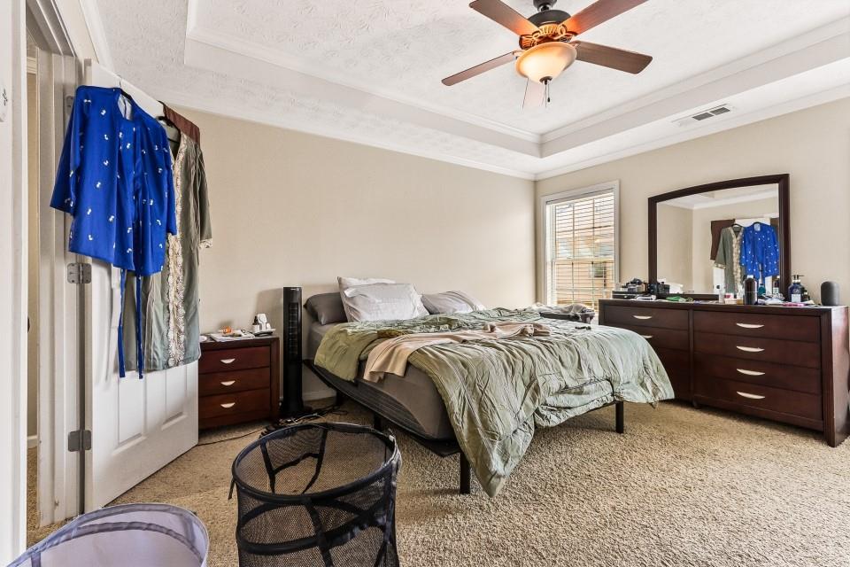 1946 Appaloosa Mill Circle Northeast Buford, GA 30519 - Photo 11 of 20 a bed room with a bed and a dresser