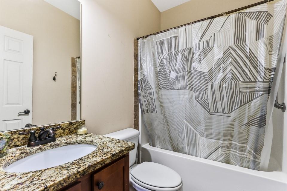 1946 Appaloosa Mill Circle Northeast Buford, GA 30519 - Photo 15 of 20 a bathroom with a granite countertop sink and a mirror