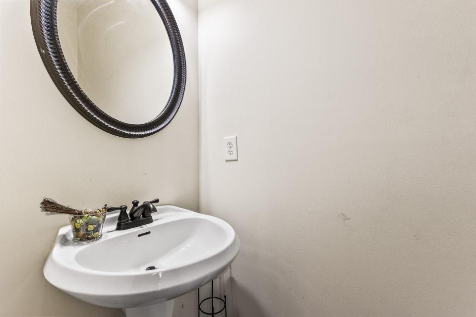 1946 Appaloosa Mill Circle Northeast Buford, GA 30519 - Photo 17 of 20 a bathroom with a sink and a mirror
