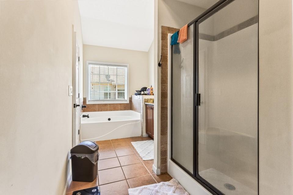 1946 Appaloosa Mill Circle Northeast Buford, GA 30519 - Photo 18 of 20 a bathroom with a bathtub and a shower