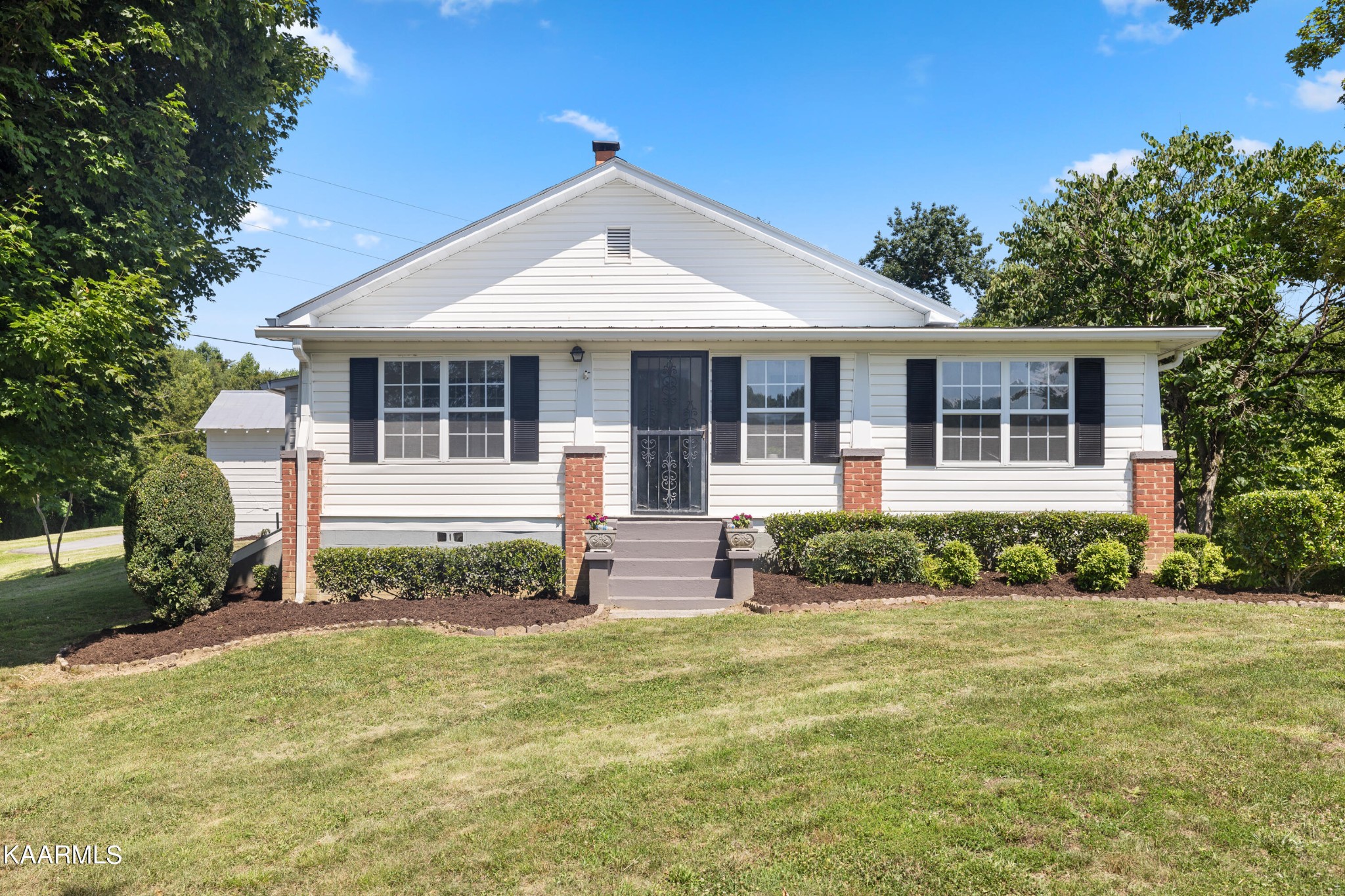 3044 Sims Road Sevierville, TN 37876 - Photo 1 of 34 a front view of a house with garden