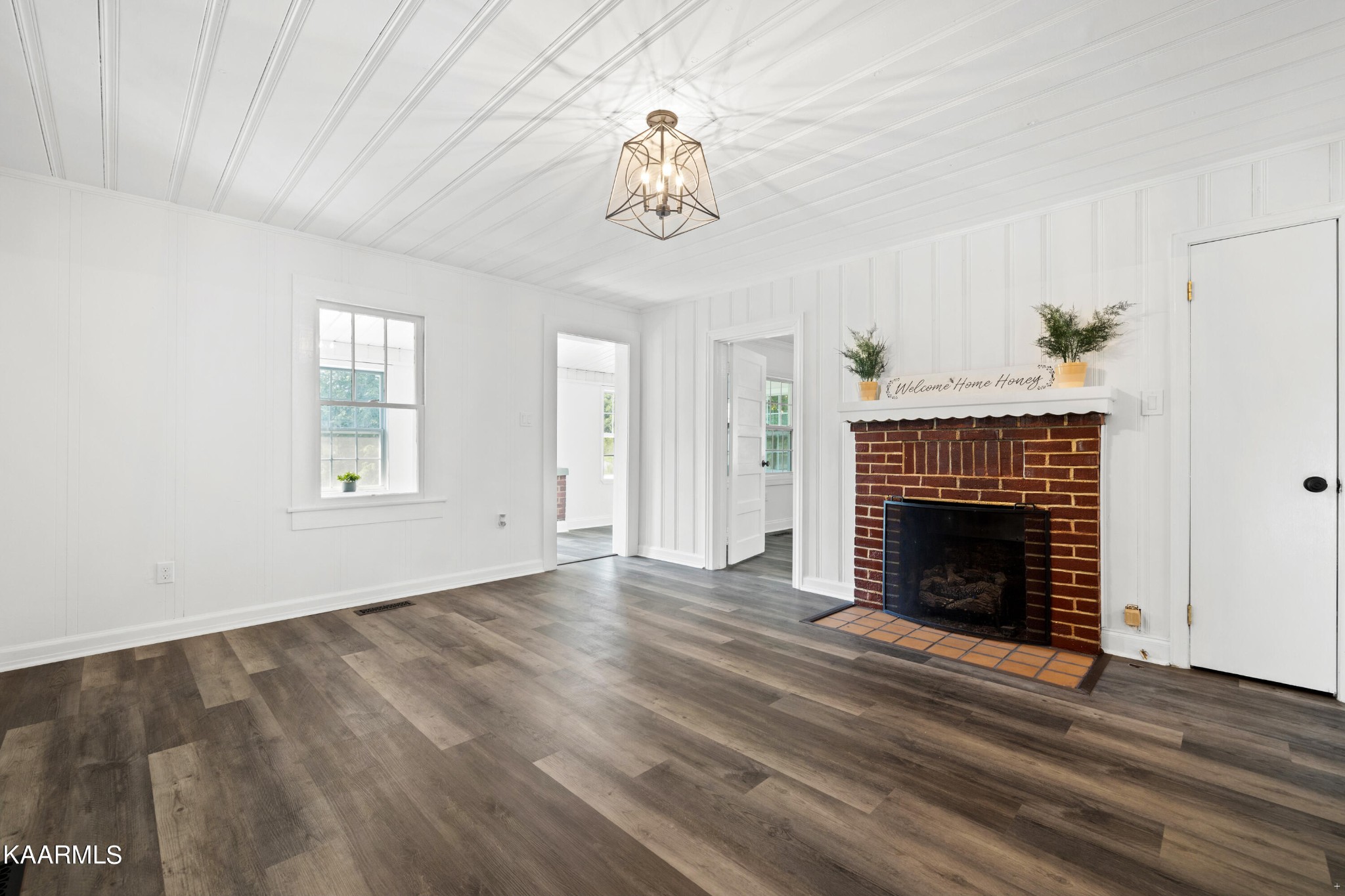 3044 Sims Road Sevierville, TN 37876 - Photo 14 of 34 a view of an empty room with wooden floor fireplace and a window