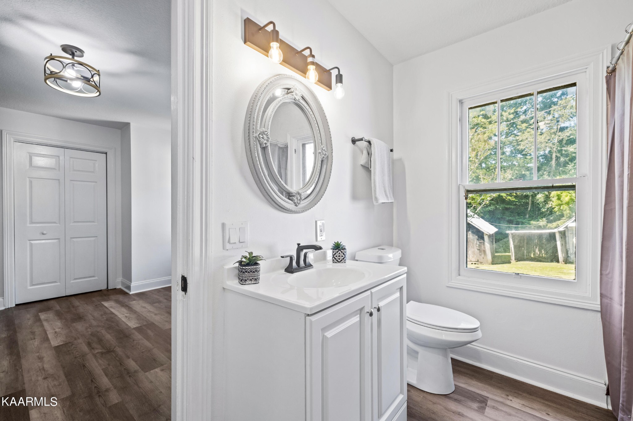3044 Sims Road Sevierville, TN 37876 - Photo 21 of 34 a bathroom with a toilet sink vanity and mirror
