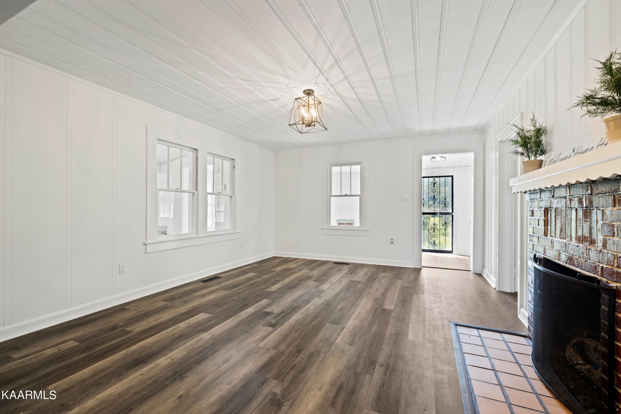 3044 Sims Road Sevierville, TN 37876 - Photo 6 of 34 a view of an empty room with wooden floor and a window