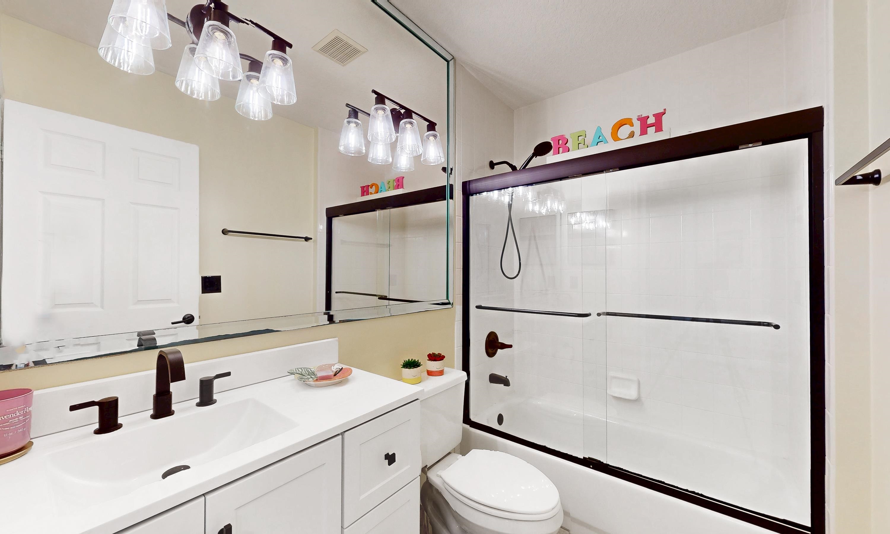 705 Augusta Circle St. Augustine, FL 32086 - Photo 27 of 52 a bathroom with a sink a mirror and a shower