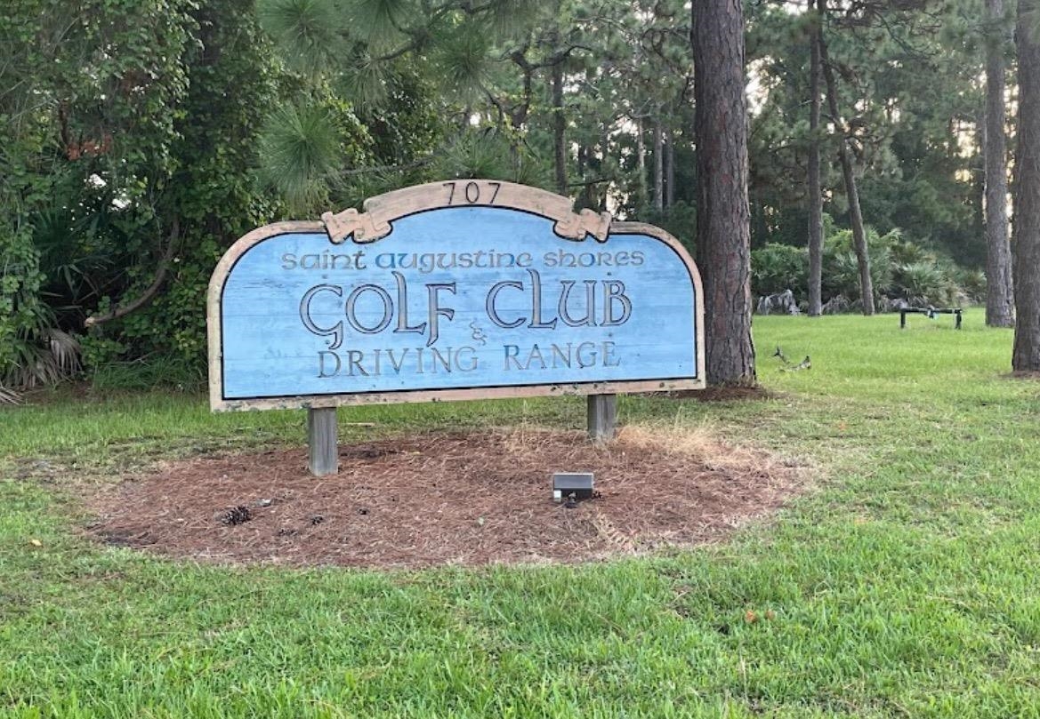 705 Augusta Circle St. Augustine, FL 32086 - Photo 45 of 52 a wooden bench sitting in the middle of a park