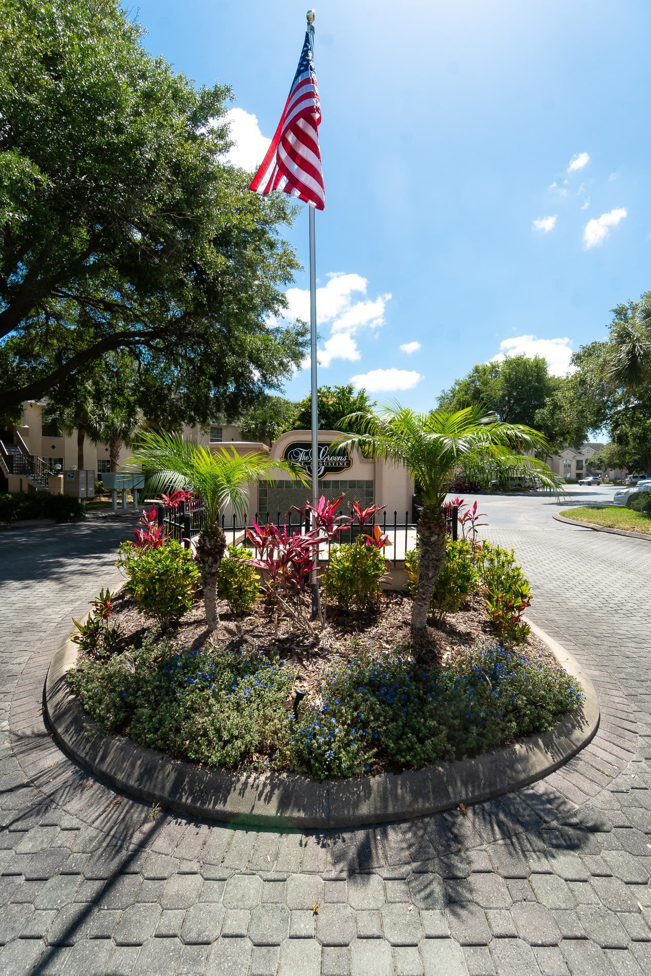 705 Augusta Circle St. Augustine, FL 32086 - Photo 48 of 52 a front view of a house with a yard and potted plants