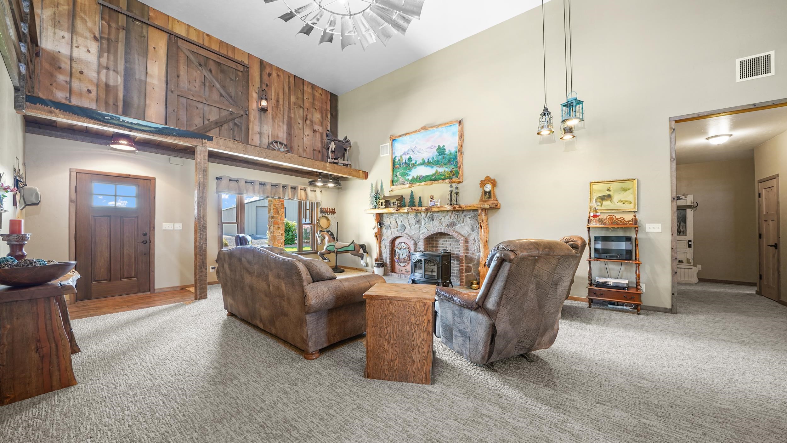 1029 25 Road Grand Junction, CO 81505 - Photo 13 of 41 a living room with furniture a fireplace and a chandelier