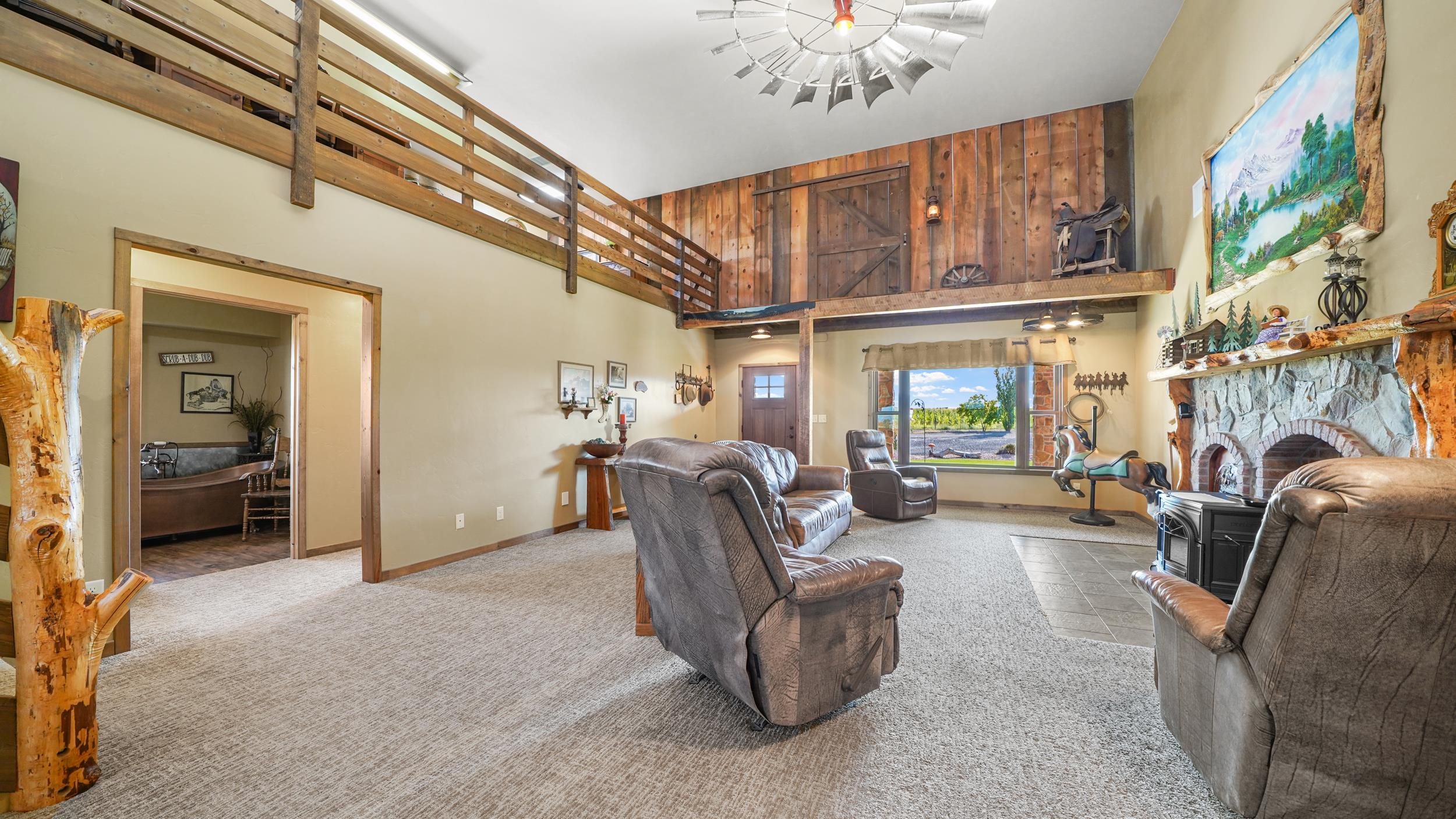 1029 25 Road Grand Junction, CO 81505 - Photo 15 of 42 a living room with furniture a fireplace and a chandelier