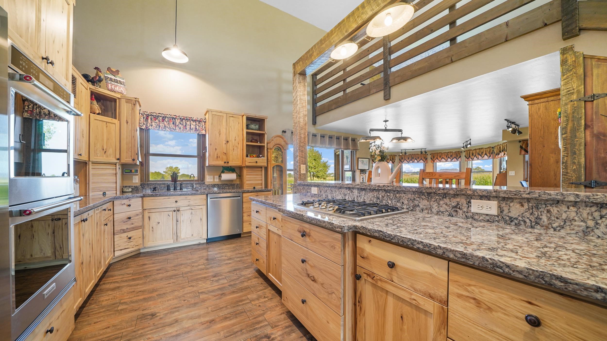 1029 25 Road Grand Junction, CO 81505 - Photo 16 of 41 a kitchen with stainless steel appliances granite countertop a lot of counter space and wooden floors