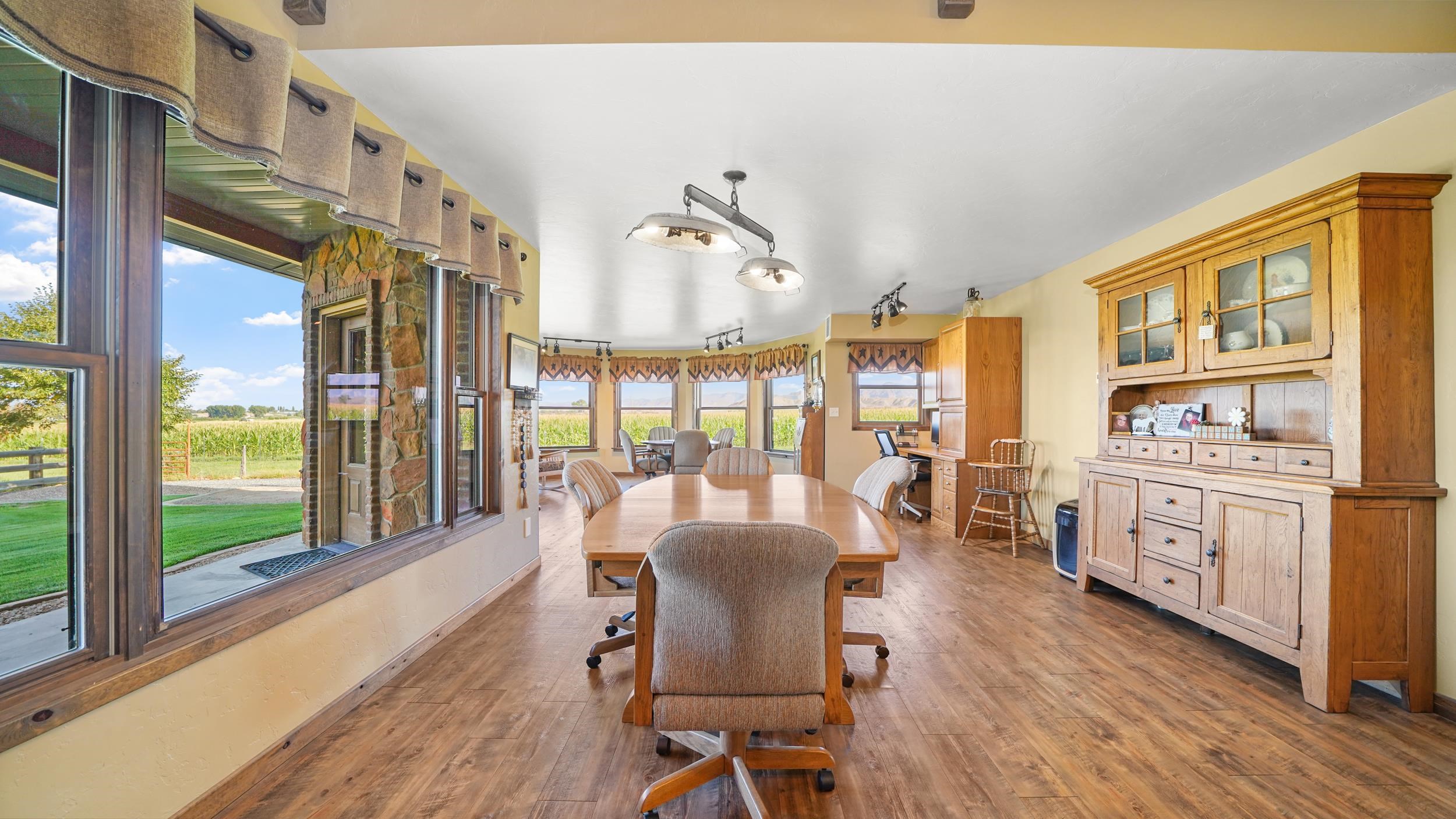 1029 25 Road Grand Junction, CO 81505 - Photo 21 of 42 a view of a dining room with furniture window and wooden floor