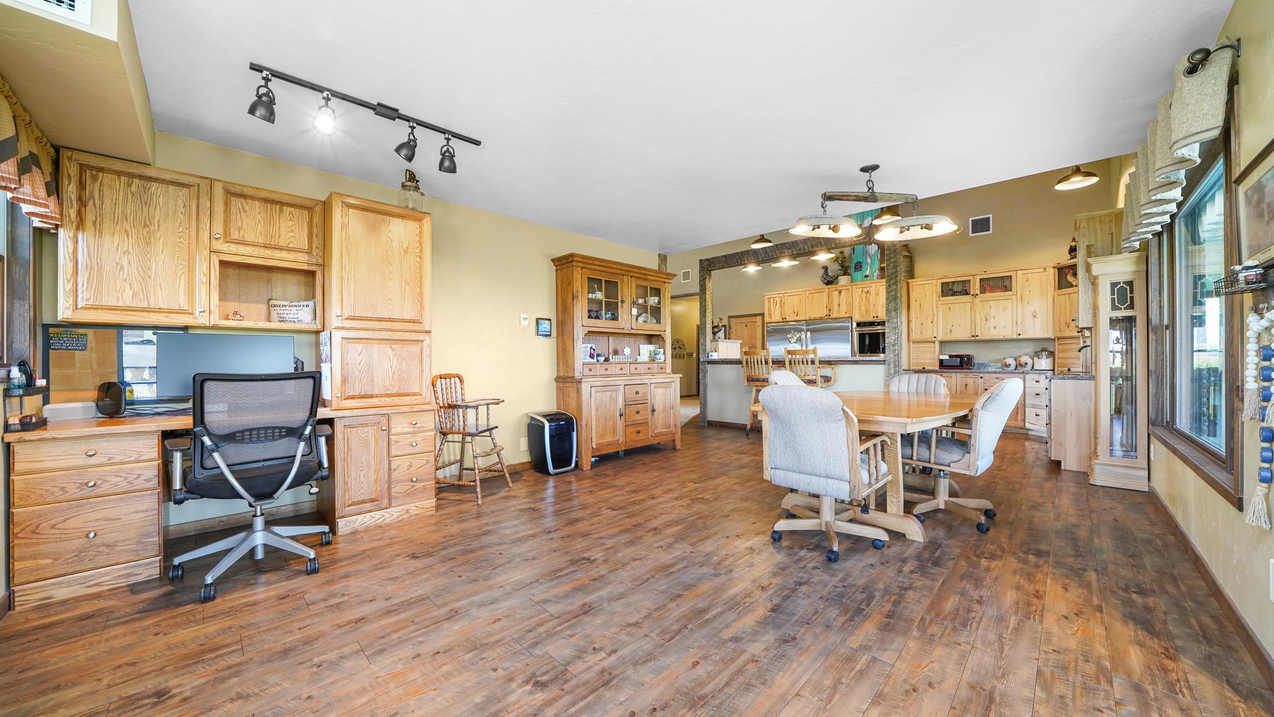 1029 25 Road Grand Junction, CO 81505 - Photo 23 of 42 a view of a dining room with furniture and wooden floor
