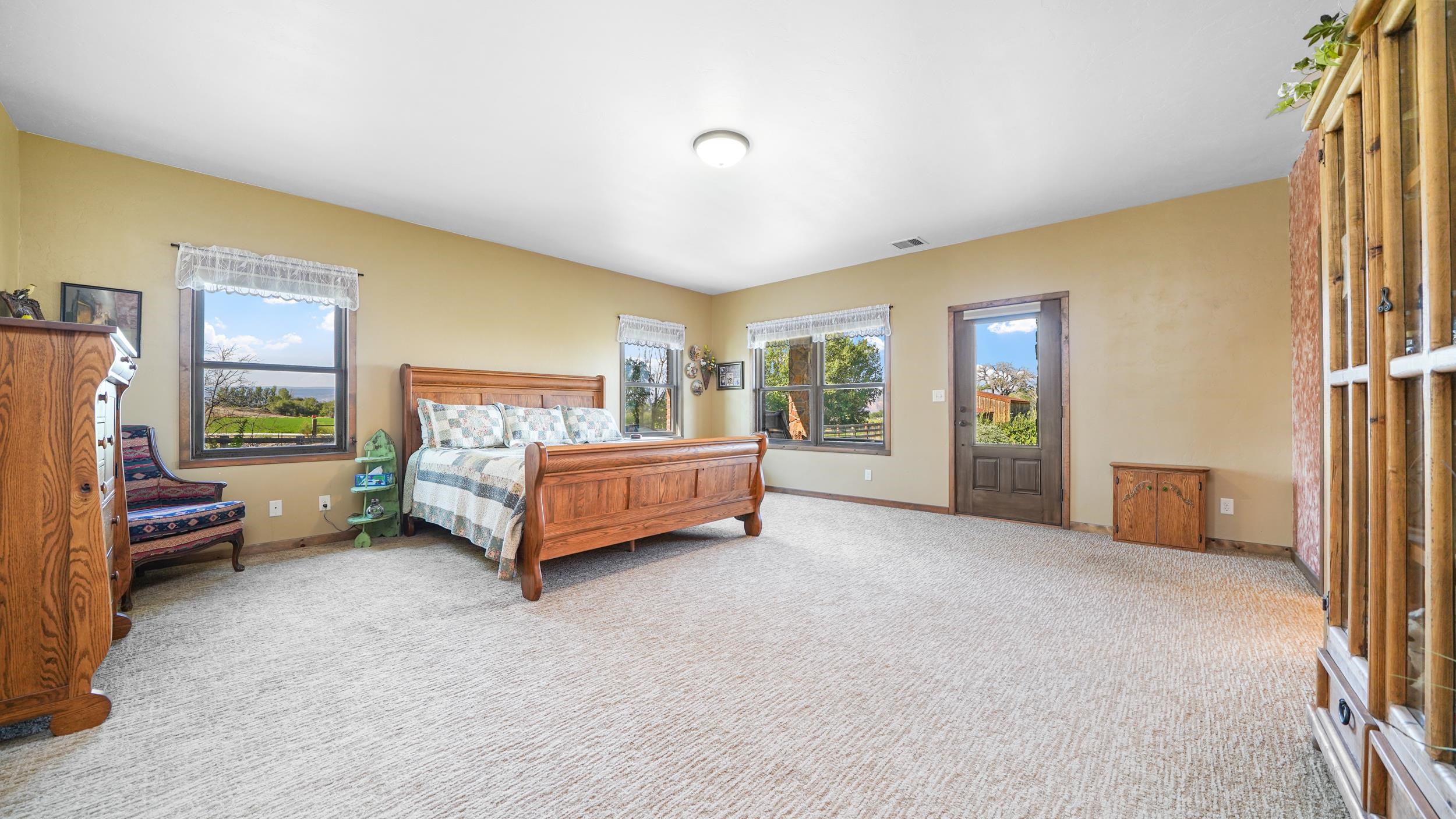 1029 25 Road Grand Junction, CO 81505 - Photo 24 of 42 a spacious bedroom with a bed and a couch
