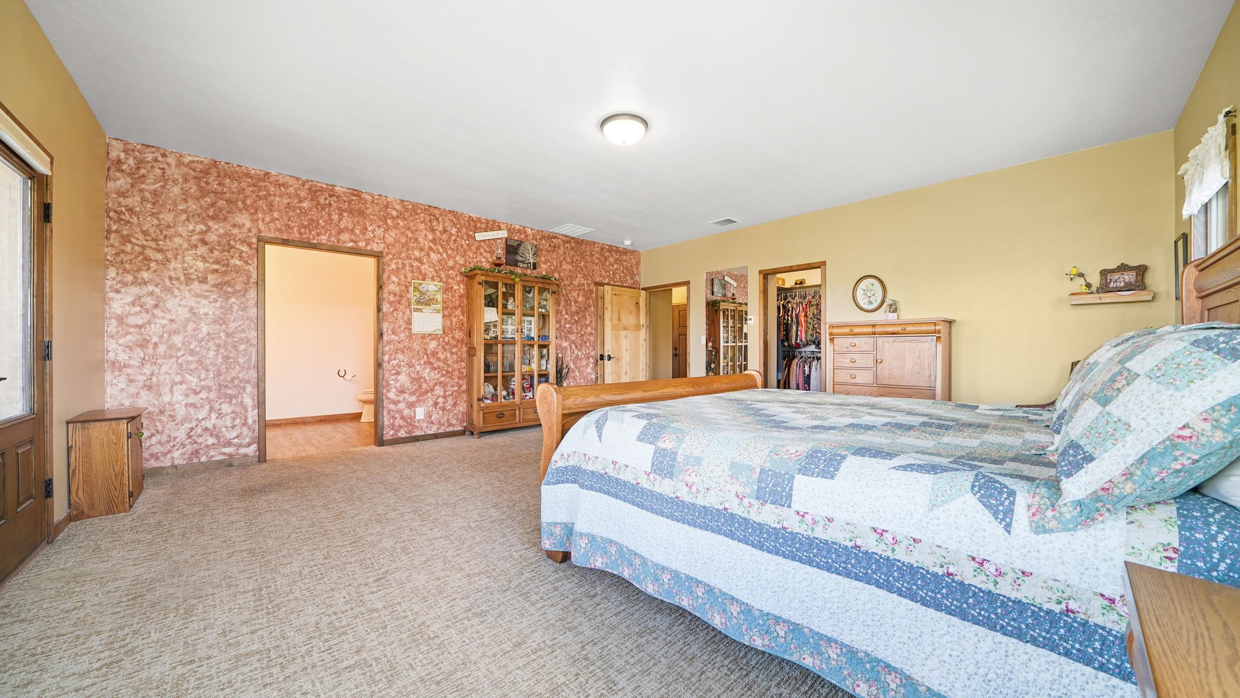 1029 25 Road Grand Junction, CO 81505 - Photo 25 of 42 a spacious bedroom with a bed and a cabinets