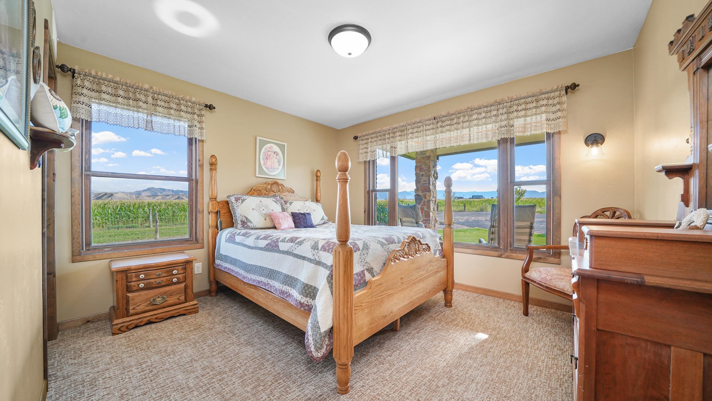 1029 25 Road Grand Junction, CO 81505 - Photo 28 of 42 a bed sitting in a spacious bedroom next to a window