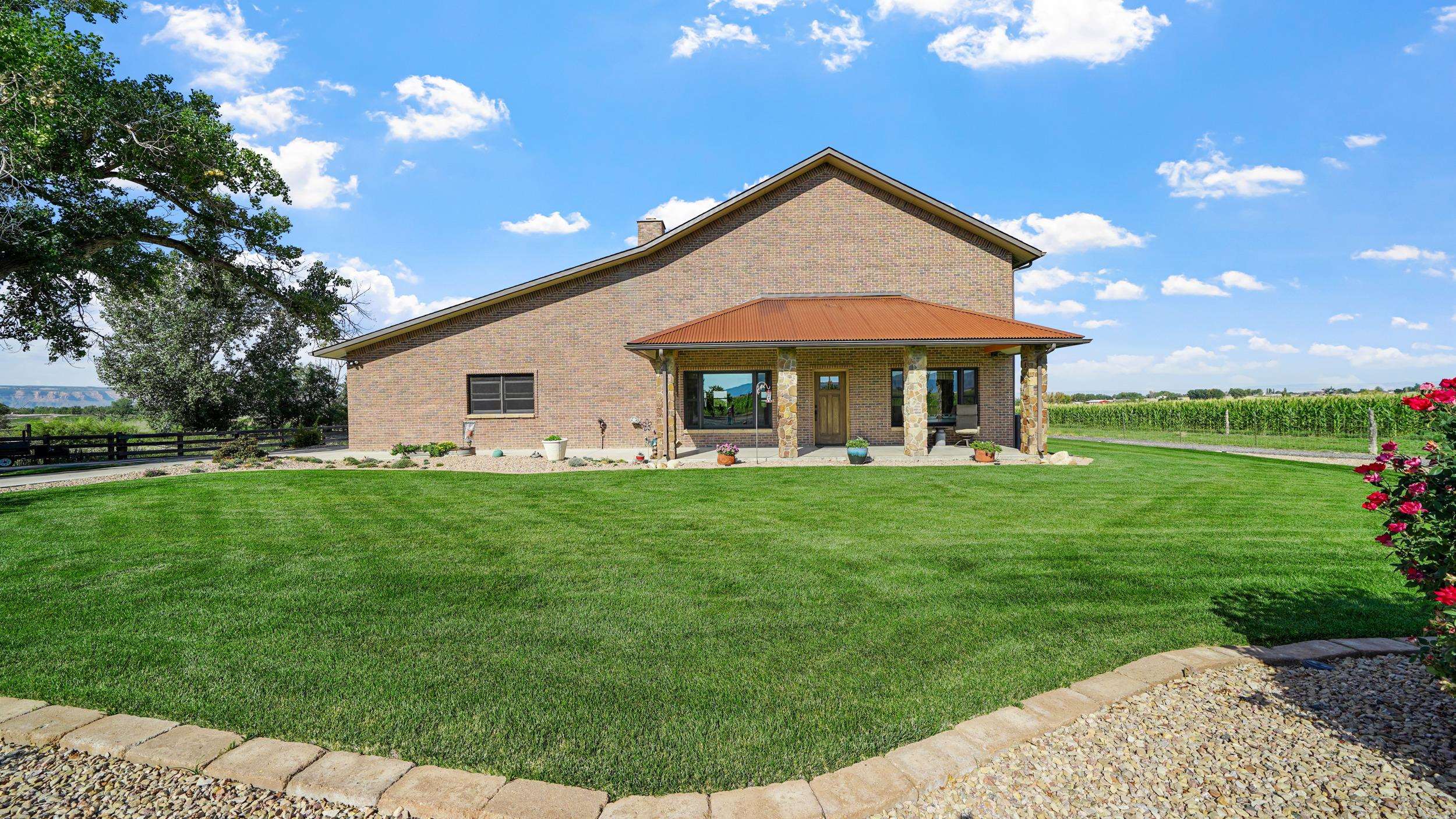 1029 25 Road Grand Junction, CO 81505 - Photo 7 of 42 a front view of a house with a yard
