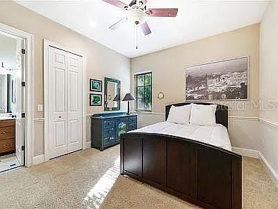 234 Acadia Terrace Celebration, FL 34747 - Photo 11 of 38 a bedroom with a bed and a chandelier