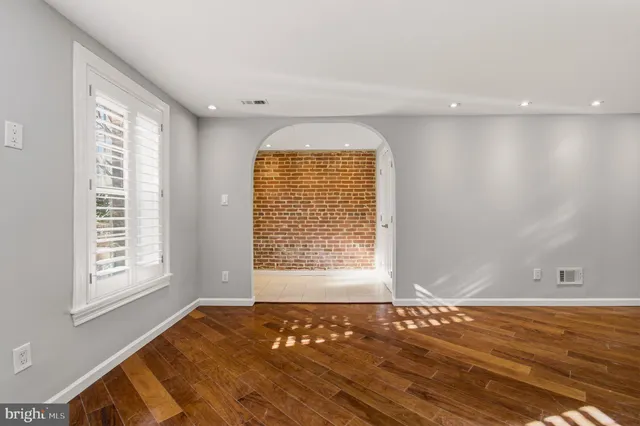 a view of kitchen with wooden floor and a window