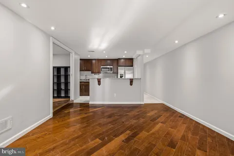 a view of empty room with wooden floor
