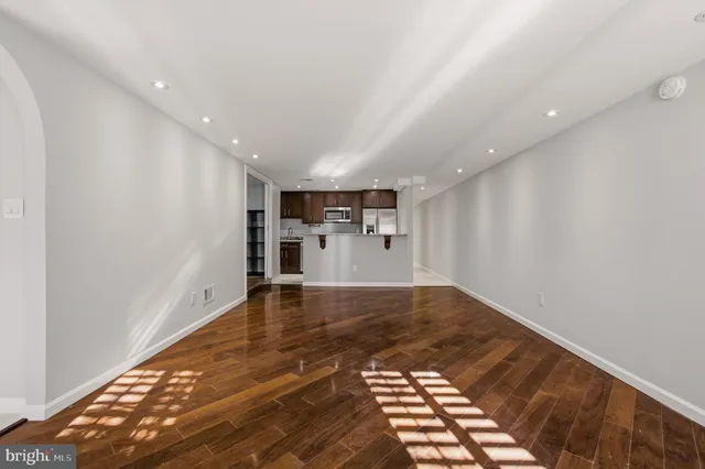 a kitchen with a stove and a wooden floor