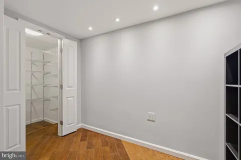 a kitchen with a stove and a wooden floor