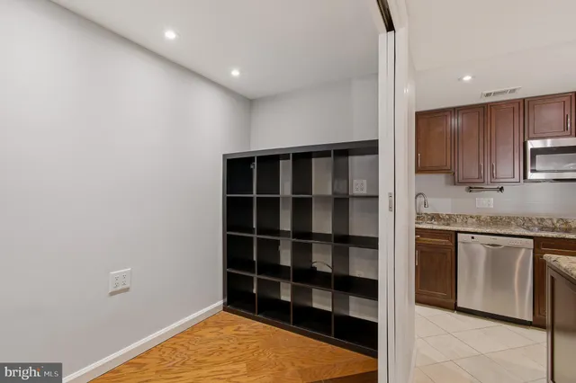 a kitchen with granite countertop stainless steel appliances and cabinets