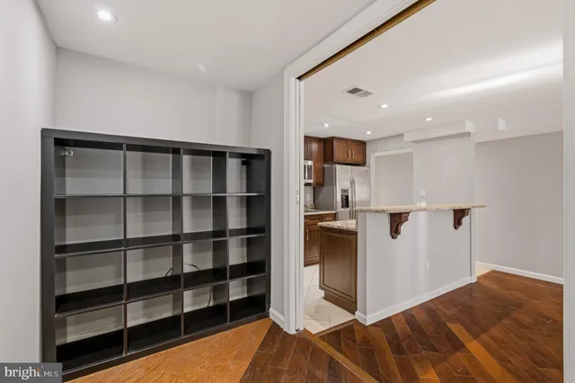 a kitchen with kitchen island a sink stove and refrigerator