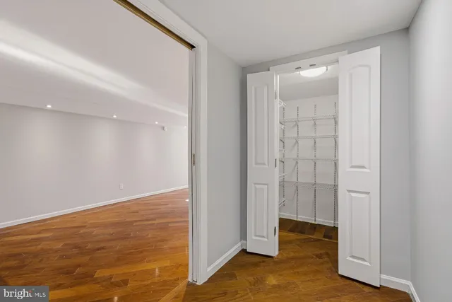 a kitchen with stainless steel appliances kitchen island granite countertop a refrigerator and cabinets