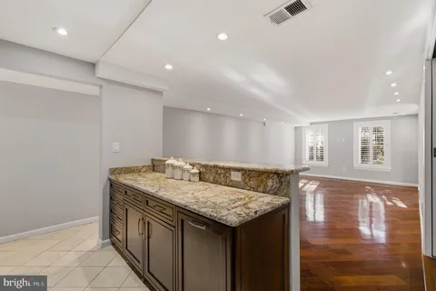 a kitchen with granite countertop stainless steel appliances and wooden cabinets
